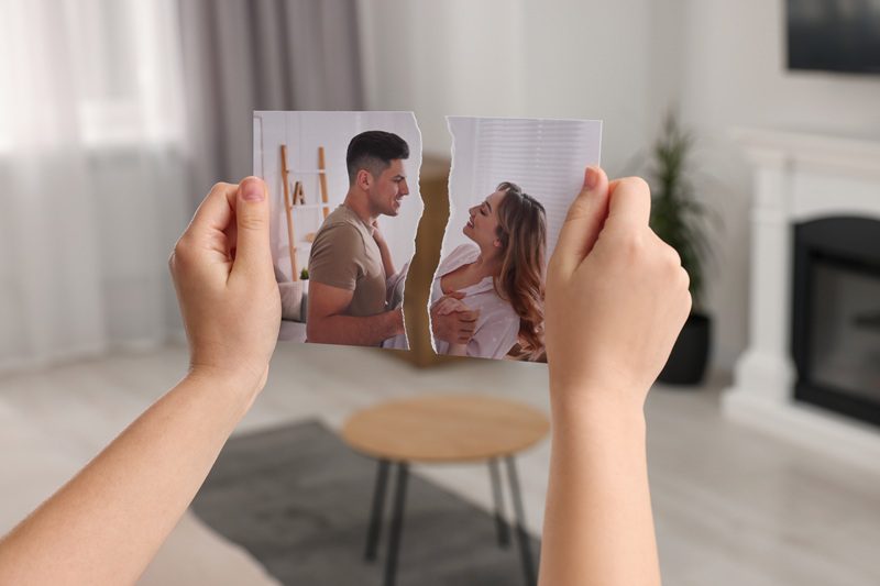 A picture of a couple ripped in half, showing separation.
