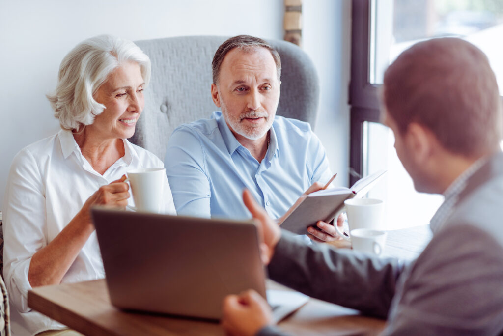 An older couple is having a discussion with a Charlotte divorce attorney.