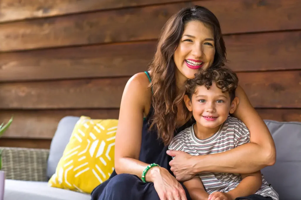 Mother embracing her young son at home, symbolizing child custody, parenting rights, and family stability during legal proceedings.