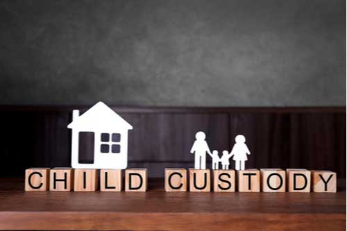 Paper cutout house and family on blocks with words child custody. Lincoln County family law attorney concept