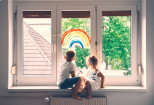 This is an image of children sitting at a window concept of child support with a Gastonia divorce lawyer