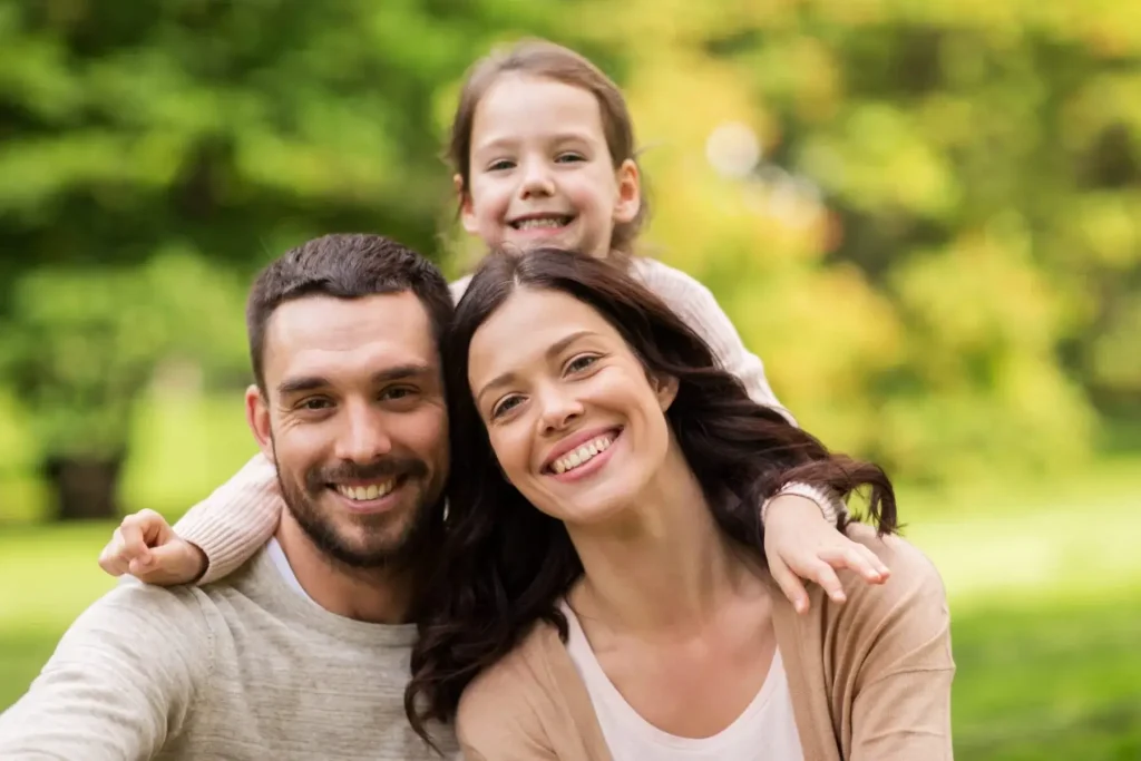 Smiling family outdoors representing child custody, divorce, and family law support in Huntersville, NC.