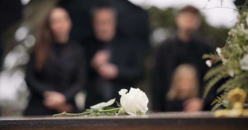 A family is gathered at a funeral after a loved one passed from a fatal workplace injury.