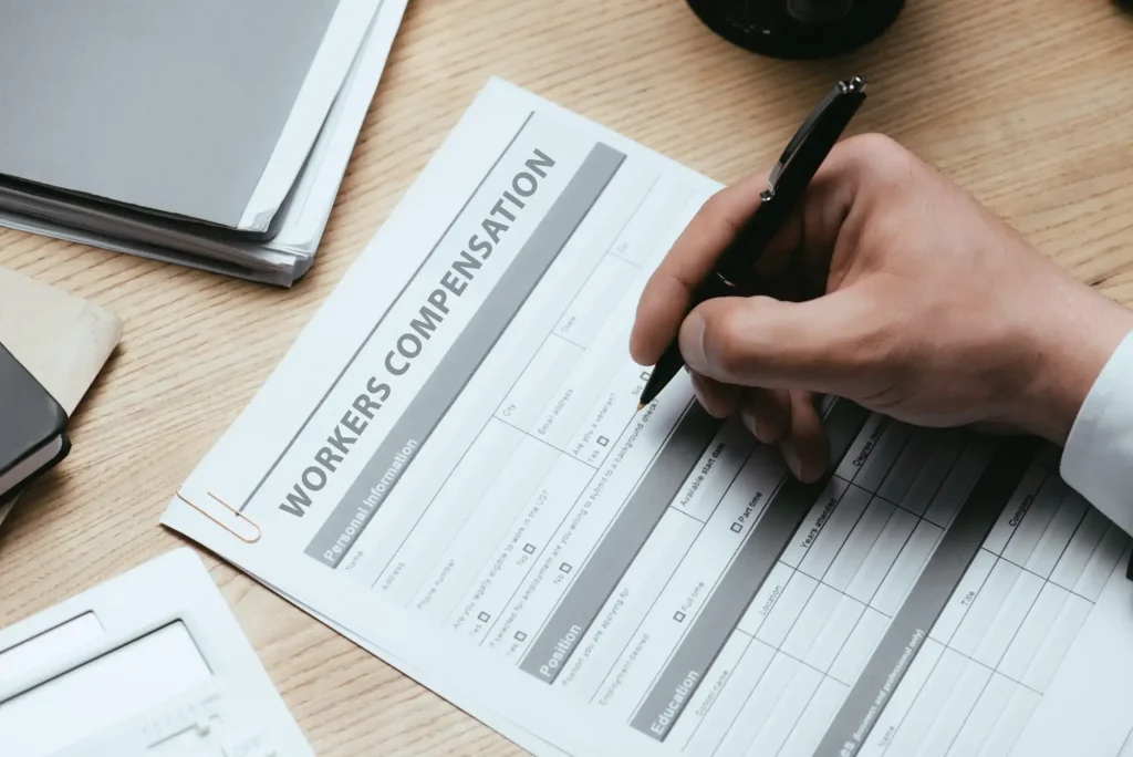 Injured worker completing workers’ compensation appeal paperwork after a denied or disputed claim.