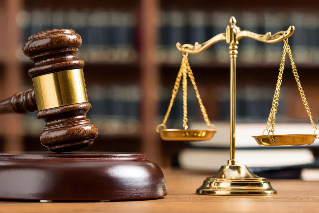 A gavel and scale representing how our Charlotte workers' comp attorneys can help with your case.