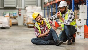 A man that with hurt knee on ground while on the job, to show Work Injuries in Charlotte