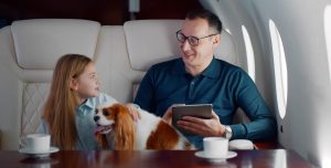 A man with daughter on private plane, to show wealth and needing a good Charlotte High Net Worth Divorce Lawyer.