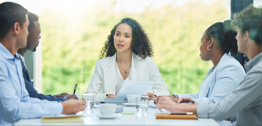A mediator sits at a table discussing a possible resolution for a workers' compensation issue.